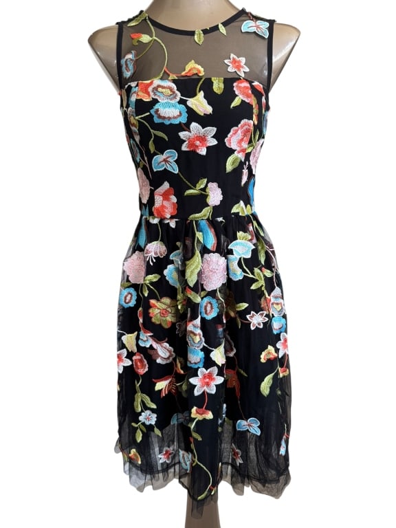 NEW YORK AND COMPANY FLIRTY BLACK MESH DRESS: FLIRTY AND FEMININE BLACK MESH DRESS FEATURING MULTI-COLOR FLORAL EMBROIDERY THROUGHOUT. THIS SLEEVELESS DRESS SHOWCASES A FITTED BODICE WITH A SHEER ILLUSION NECKLINE AND A FULL, FLOWING SKIRT THAT H