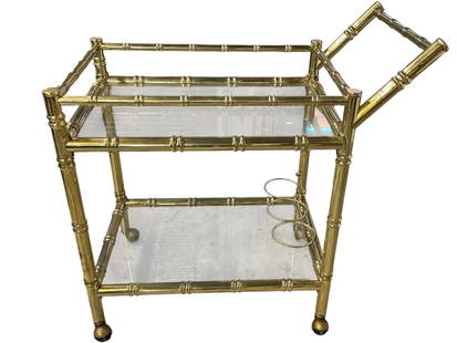 VINTAGE FAUX BAMBOO BRASS AND GLASS BAR CART: VINTAGE FAUX BAMBOO BRASS AND GLASS BAR CART WITH BOTTLE HOLDER | FLORIDA REGENCY STYLE ELEGANT VINTAGE BAR CART FEATURING A FAUX BAMBOO BRASS FRAME WITH TWO CLEAR GLASS SHELVES. INCLUDES A BUILT-IN B