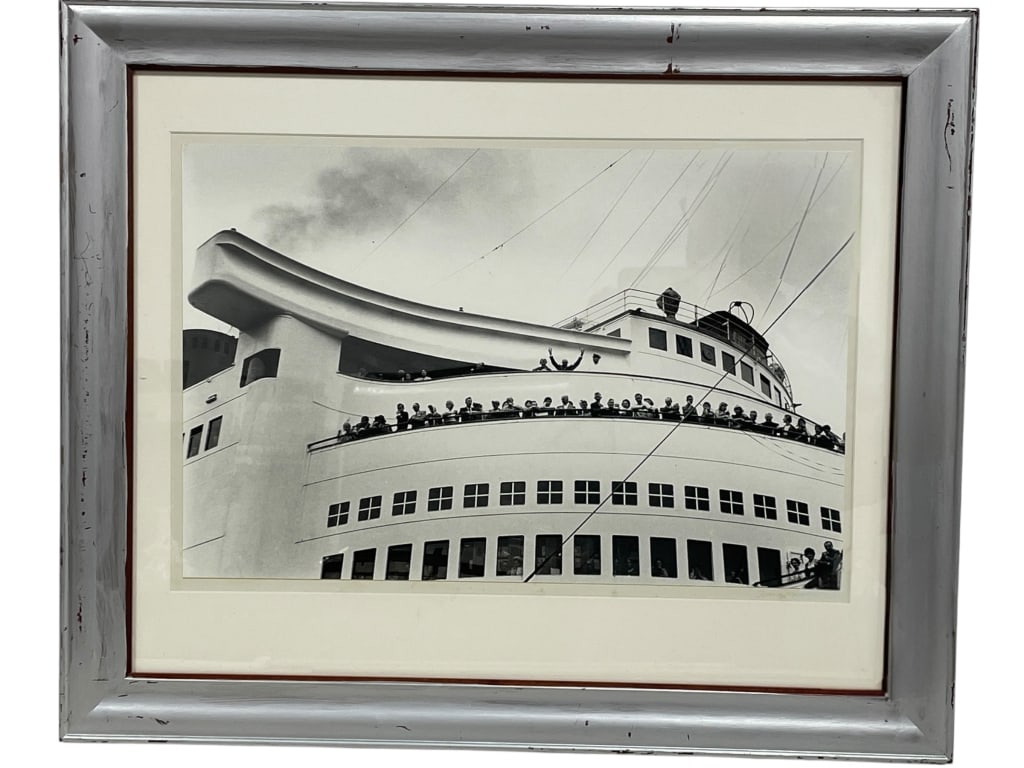 EISENHOWER CRUISE SHIP PHOTO PRINT 23": BLACK AND WHITE PHOTOGRAPH CAPTURING FORMER PRESIDENT DWIGHT D. EISENHOWER (TOP CENTER) AND HIS WIFE, MAMIE EISENHOWER, WAVING FROM THE UPPER DECK OF A SHIP AS THEY PREPARE TO SAIL FOR EUROPE. THE IMA