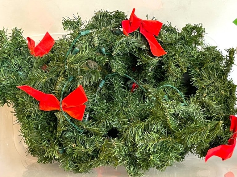BIN OF ARTIFICIAL PRE LIT HOLIDAY GARLAND W/ BOWS