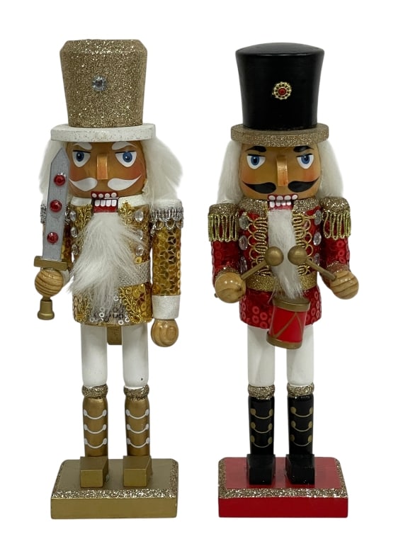 PAIR HAND-PAINTED WOODEN CHRISTMAS NUTCRACKERS: TWO FESTIVE, HAND-PAINTED WOODEN CHRISTMAS NUTCRACKERS IS PRESENTED. THE NUTCRACKERS ARE A MATCHING PAIR, BOTH WEARING SEQUINED JACKETS, WHITE PANTS, AND TOP HATS. ONE NUTCRACKER WEARS A RED SEQUINED