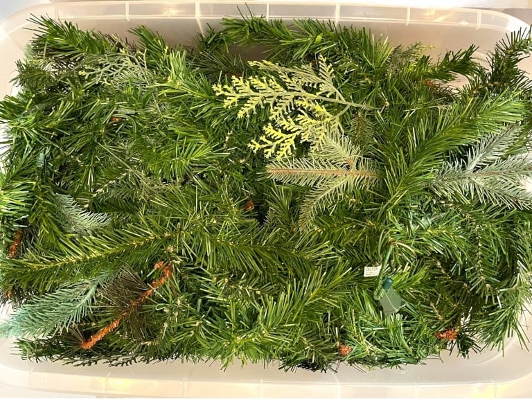 BIN OF MIXED ARTIFICIAL EVERGREEN GARLAND: BIN OF REALISTIC MIXED ARTIFICIAL EVERGREEN GARLAND -GOOD PRE OWNED CONDITION, SEE PHOTOS -HOLIDAY GARLAND FEATURING A VARIETY OF PINE, FIR, AND CEDAR-STYLE NEEDLES FOR A NATURAL, WOODLAND LOOK. INCLU