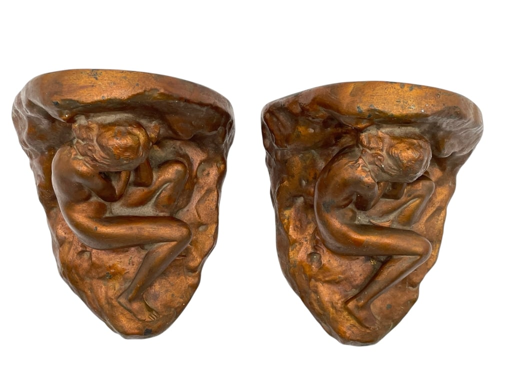 PAIR OF ART NOUVEAU STYLE BOOKENDS 8": PAIR OF ART NOUVEAU STYLE BOOKENDS 8" -VERY GOOD PRE OWNED CONDITION -APPROX 8" -CAST METAL DESIGN FEATURING NUDE FEMALE FIGURES IN REPOSE WITHIN A CAVE-LIKE FORM. WARM COPPER-TONE FINISH -JA 041025 B