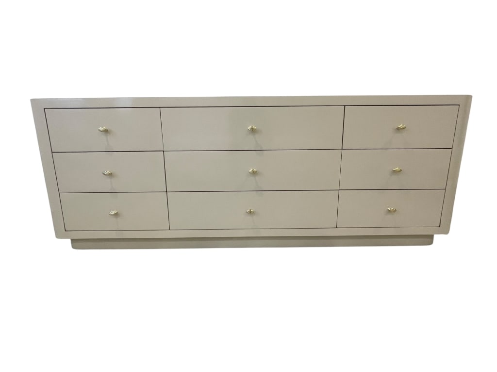 NINE-DRAWER MODERN DRESSER 79": NINE-DRAWER MODERN DRESSER WITH GOLD-TONE HARDWARE. FEATURES A SLEEK BEIGE FINISH AND CLEAN LINES, PERFECT FOR A CONTEMPORARY BEDROOM. QUALITY WOOD CONSTRUCTION WITH SMOOTH DRAWER GLIDES AND AMPLE STO