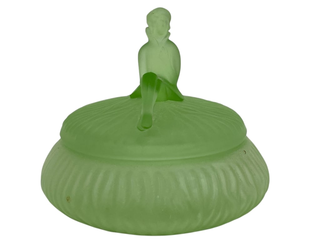 GREEN SATIN FROSTED GLASS POWDER JAR 5.5": GREEN SATIN FROSTED GLASS POWDER JAR WITH FIGURAL LID -VERY GOOD PRE OWNED CONDITION -APPROX 5.5"W X 5.5"H -FEATURES A SEATED FIGURE ON TOP OF A RIBBED ROUND BASE. BEAUTIFUL SATIN FINISH WITH SUBTLE P