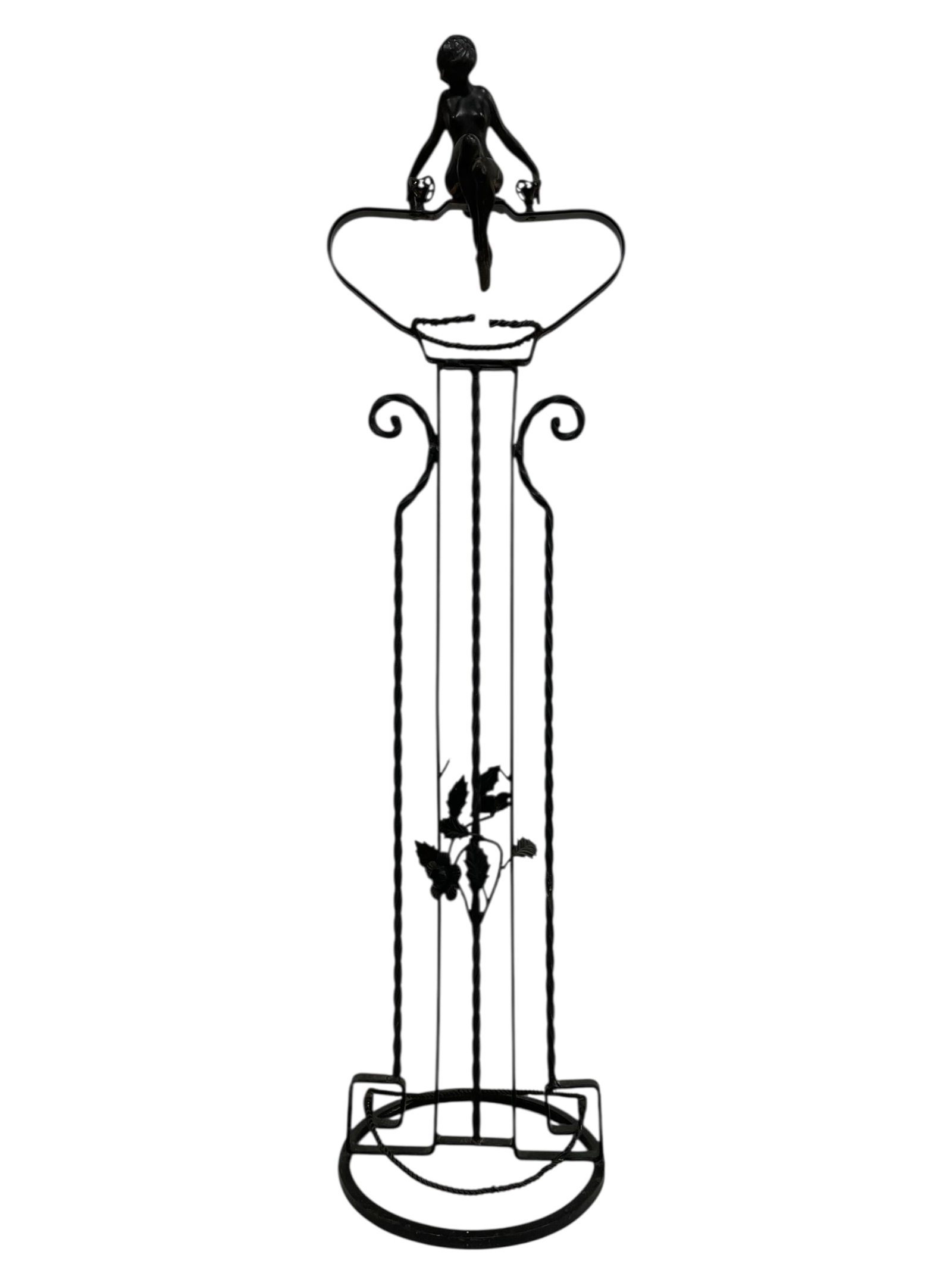 VINTAGE WROUGHT IRON UMBRELLA STAND 25": VINTAGE WROUGHT IRON UMBRELLA STAND WITH FIGURAL WOMAN MOTIF 25" -VERY GOOD PRE OWNED CONDITION -APPROX 25" X 8" -THIS DECORATIVE STAND FEATURES A TWISTED IRON FRAME WITH LEAF DETAILING, CIRCULAR BASE