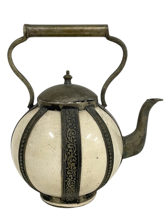 CERAMIC AND METAL TEAPOT WITH CRACKLE GLAZE 9": CERAMIC AND METAL TEAPOT WITH CRACKLE GLAZE 9" -VERY GOOD PRE OWNED CONDITION -APPROX 9"H X 8"W -THIS DISTINCTIVE TEAPOT FEATURES A ROUND BODY WITH CREAM-COLORED CRACKLE GLAZE, DECORATED WITH ORNATE E