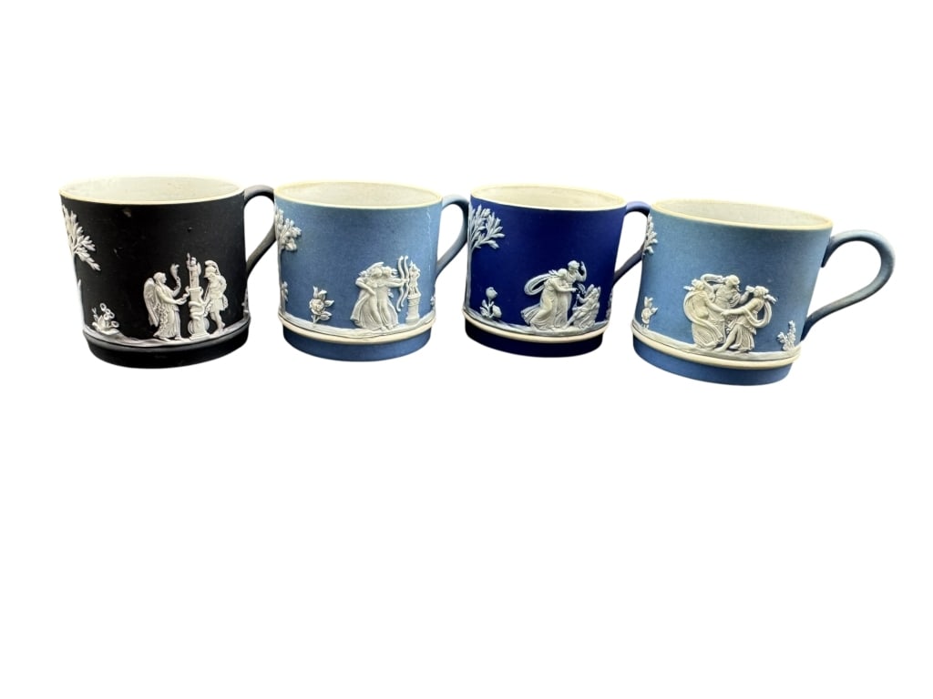 SET OF FOUR WEDGWOOD JASPERWARE DEMI CUPS: SET OF FOUR WEDGWOOD JASPERWARE DEMI CUPS – Collection of four classic Wedgwood Jasperware demi cups measuring approximately 2" high, in black, light blue, and dark blue. Each cup is decorated with