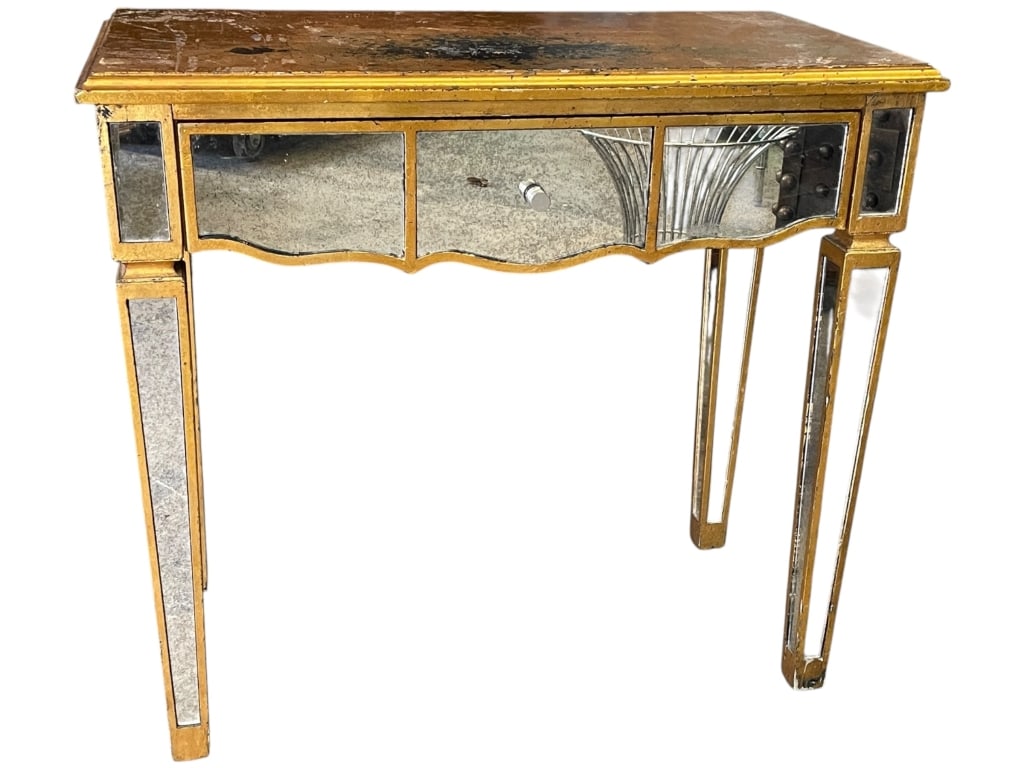 ANTIQUE STYLE MIRRORED CONSOLE TABLE DESK: ANTIQUE STYLE MIRRORED CONSOLE TABLE DESK | ANTIQUE STYLE GOLD GILT AND MIRRORED CONSOLE TABLE WITH SINGLE DRAWER. THIS DECORATIVE TABLE FEATURES A GILDED WOODEN FRAME INSET WITH AGED MIRRORED PANELS,