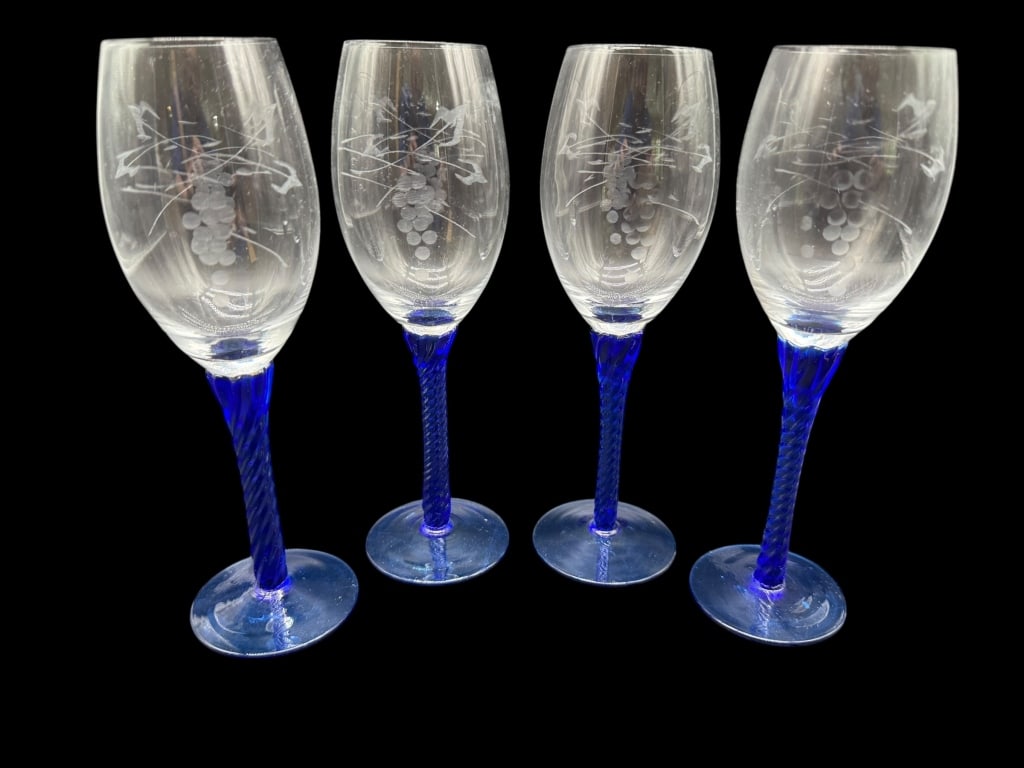 SET OF FOUR COBALT BLUE STEM WINE GLASSES: SET OF FOUR COBALT BLUE STEM WINE GLASSES WITH ETCHED GRAPE MOTIFElegant set of four wine glasses featuring clear bowls etched with grape clusters and vines, paired with twisted cobalt blue stems and
