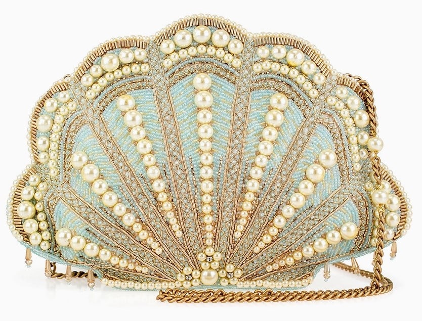 NEW MARY FRANCES SEASIDE LUXURY SHELL HANDBAG: Seaside Luxury Handbag captures the elegance of ocean treasures with its shimmering shell design and pearl accents. The soft blue tones and golden details evoke the beauty of a seaside escape. Perfect