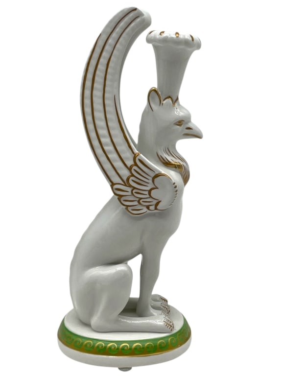 PORCELAIN GRIFFIN FIGURAL CANDLESTICK 9": PORCELAIN GRIFFIN FIGURAL CANDLESTICK WITH GILT ACCENTS -Very good pre owned condition -Approx 9"h x 3"w x 3.5" -Made in Italy -Striking porcelain candlestick in the form of a seated griffin, finely m