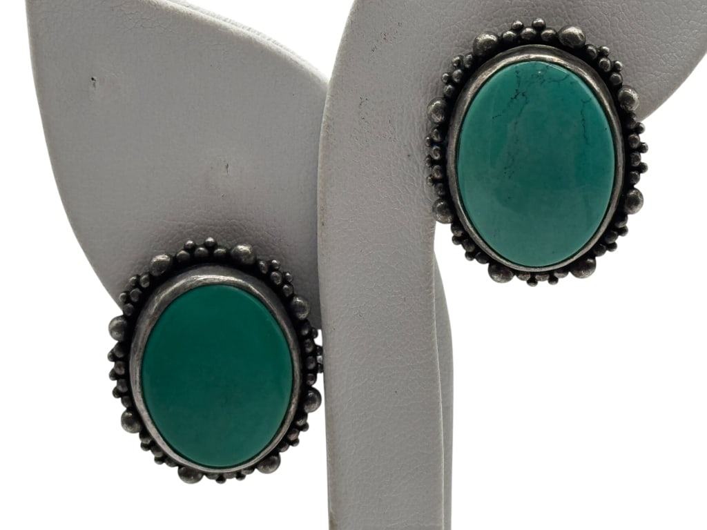 STERLING SILVER & TURQUOISE EARRINGS BY SAKO DERA: STERLING SILVER & TURQUOISE EARRINGS BY SAKO DERA VINTAGE CLIP-ON EARRINGS SIGNED BY NOTED DESIGNER SAKO DERA, CRAFTED IN STERLING SILVER AND SET WITH LARGE OVAL TURQUOISE STONES. DETAILED BEADED BORD
