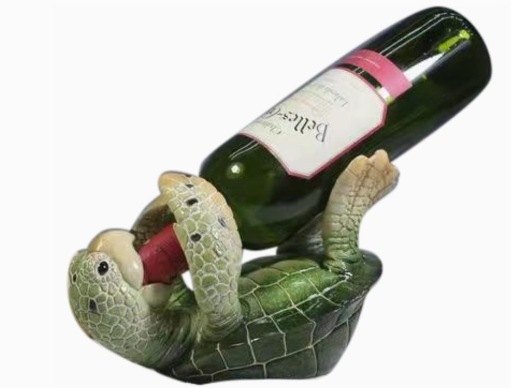 GREEN TURTLE WINE HOLDER NIB 8": GREEN TURTLE WINE HOLDER NIB 8" -NEW IN BOX -APPROX 8" -THIS 8" GREEN TURTLE ADDS A TOUCH OF THE SEA TO YOUR HOME DECOR. IT'S AN IDEAL PIECE FOR THOSE WHO APPRECIATE THE BEAUTY OF THE OCEAN AND ITS CR