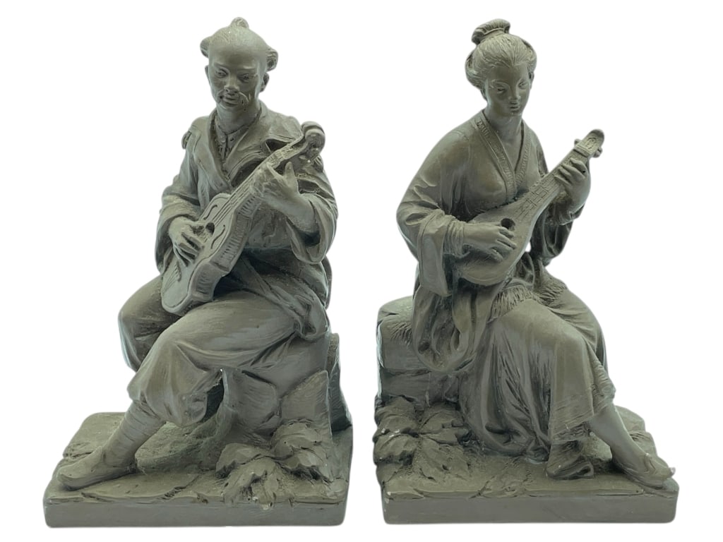FIGURINES OF MAN & WOMAN WITH STRING INSTRUMENTS: PAIR OF FIGURINES OF MAN & WOMAN WITH STRING INSTRUMENTS -Very good pre owned condition -Approx 6.5"l x 4.5"w x 11"h -Elegant pair of sculpted figurines in the Orientalist style, each finely detailed 