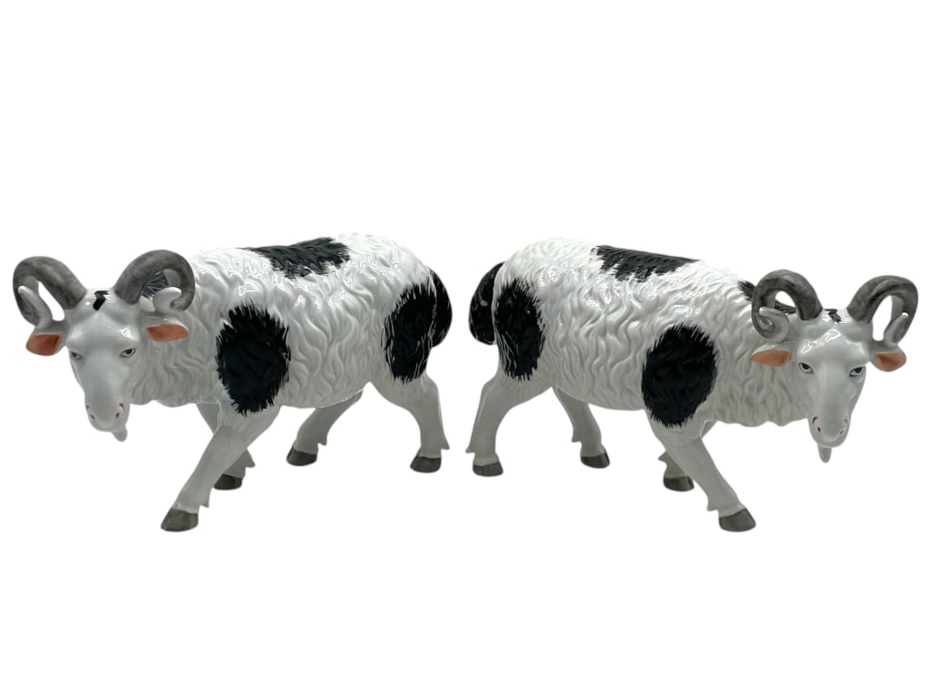 JEANNE REED'S PAIR OF PORCELAIN RAM FIGURINES 11": JEANNE REED'S PAIR OF PORCELAIN RAM FIGURINES 11" -Very good pre owned condition -Approx 6"h x 11"w -Striking pair of porcelain ram figurines featuring curled horns, black-and-white coats, and finely 