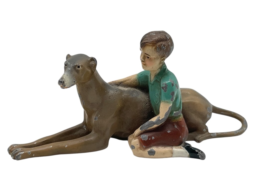 VINTAGE CAST IRON BOY W/ DOG FIGURINE 6": VINTAGE CAST IRON BOY W/ DOG FIGURINE 6" -PRE OWNED CONDITION, SEE PHOTOS -APPROX 6" X 2.5" -CHARMING ANTIQUE CAST METAL FIGURINE DEPICTING A YOUNG BOY AFFECTIONATELY SITTING BESIDE A RECLINING GREYHO