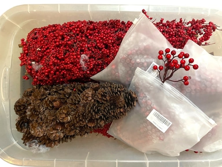 BIN OF ARTIFICIAL RED BERRIES AND PINECONE DECOR: BIN OF ARTIFICIAL RED BERRIES AND PINECONE DECOR -GOOD PRE OWNED CONDITION, SEE PHOTOS -INCLUDES MULTIPLE BAGS OF BRIGHT RED BERRY SPRAYS, BERRY TREES AND A PINECONE TREE. PERFECT FOR HOLIDAY ARRANGEM