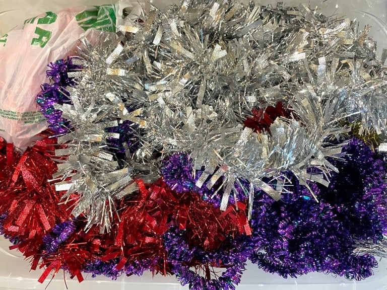 LOT OF METALLIC TINSEL GARLAND IN FESTIVE COLORS: LOT OF METALLIC TINSEL GARLAND IN FESTIVE COLORS -GOOD PRE OWNED CONDITION, SEE PHOTOS -METALLIC GARLAND IN SHIMMERING RED, PURPLE, AND SILVER. PERFECT FOR TRIMMING TREES, MANTELS, STAIRCASES, WINDOWS
