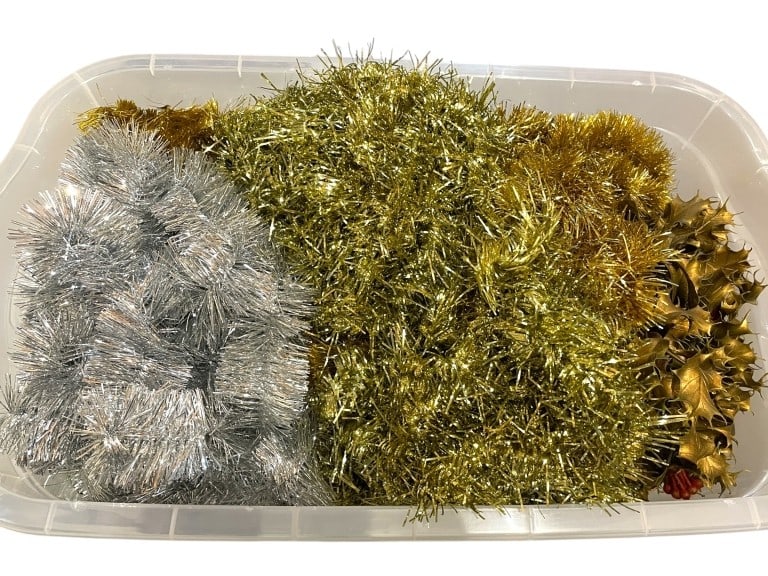 BIN OF VINTAGE-STYLE HOLIDAY TINSEL & GARLAND: BIN OF VINTAGE-STYLE HOLIDAY TINSEL & GARLAND -GOOD PRE OWNED CONDITION, SEE PHOTOS -A DAZZLING COLLECTION OF RETRO HOLIDAY DECORATIONS INCLUDING MULTIPLE STRANDS OF CLASSIC GOLD AND SILVER TINSEL GAR