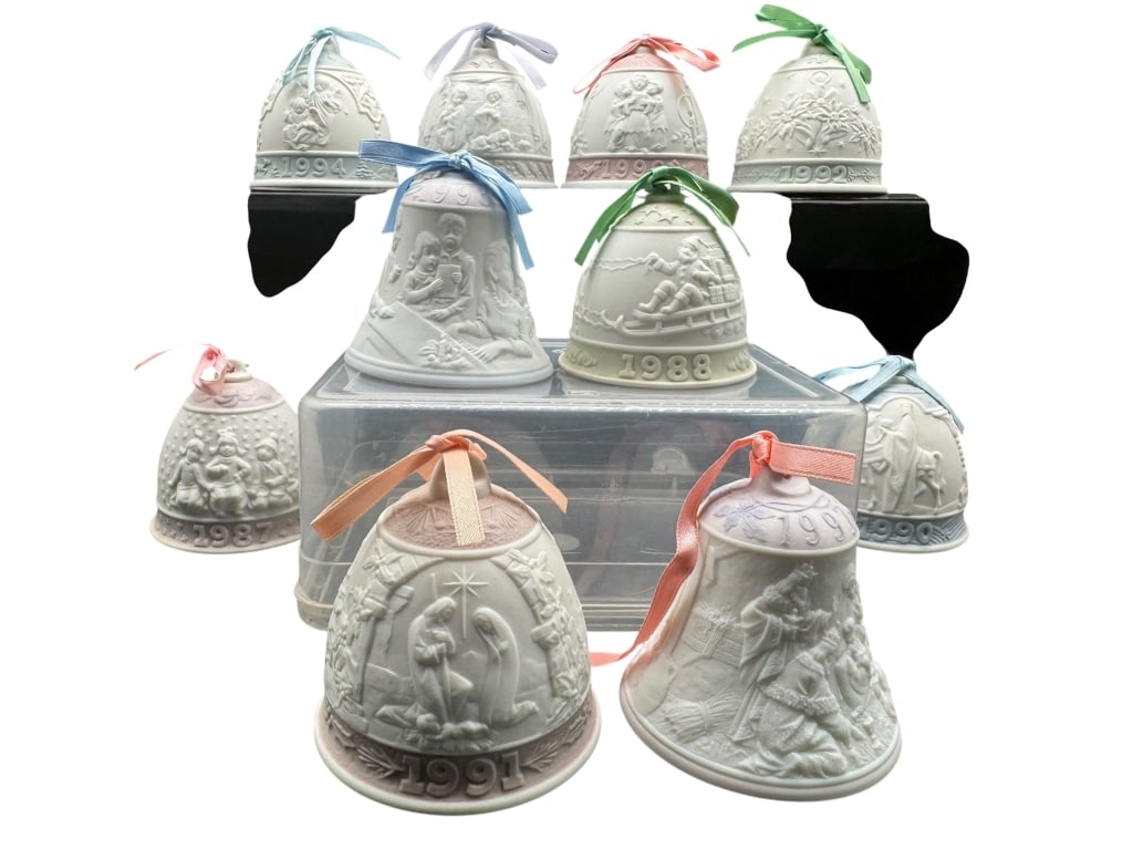 NINE WEDGWOOD JASPERWARE ANNUAL CHRISTMAS BELLS: SET OF NINE WEDGWOOD JASPERWARE ANNUAL CHRISTMAS BELLS, DATED 1987–1995. THIS BEAUTIFUL COLLECTION FEATURES WHITE RELIEF DESIGNS ON PALE BLUE, PINK, GREEN, AND LAVENDER GROUNDS, EACH WITH ORIGINAL R