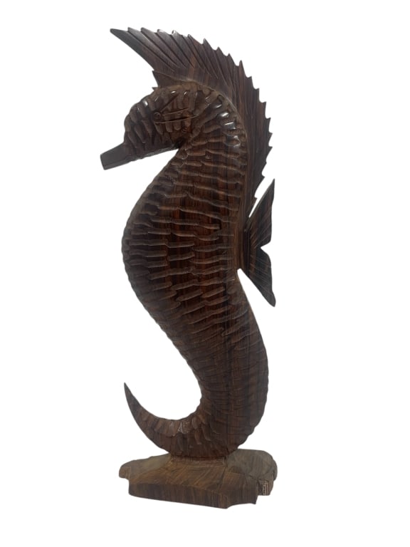 HAND-CARVED WOODEN SEAHORSE SCULPTURE 18": -STRIKING NAUTICAL DÉCOR PIECE FEATURING A TALL, CURVED SEAHORSE WITH DETAILED TEXTURING– DEEPLY CARVED RIDGES MIMIC THE NATURAL FORM OF THE SEAHORSE’S BODY AND FINS– RICH MEDIUM-BROWN WOOD WIT