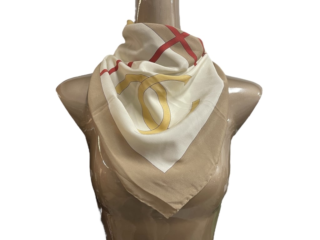 CHANEL BEIGE, CREAM & RED GEOMETRIC SILK SCARF 34": CHANEL BEIGE, CREAM & RED GEOMETRIC SILK SCARF 34" -Good pre owned condition, some stains (see photos) -Approx 34" -Modern and elegant Chanel silk scarf featuring a minimalist geometric design in soft