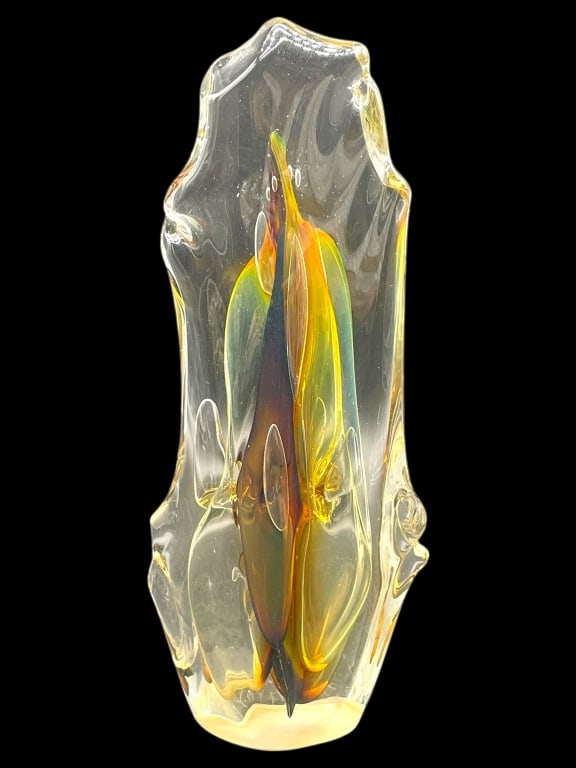 PAUL MANNERS SIGNED ART GLASS SCULPTURE 11": PAUL MANNERS SIGNED ART GLASS SCULPTURE 11" -Very good pre owned condition -Approx 11"h x 5"w -Art glass sculpture featuring a dynamic abstract form with fluid contours and internal ribbons of amber, 