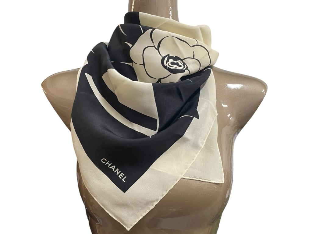 CHANEL BLACK & IVORY SILK SCARF W CAMELLIA BOW 33": CHANEL BLACK & IVORY SILK SCARF WITH CAMELLIA BOW DESIGN -Good pre owned condition, some stains (see photos) -Approx 33" -Timeless and elegant Chanel silk scarf featuring the house’s signature camel