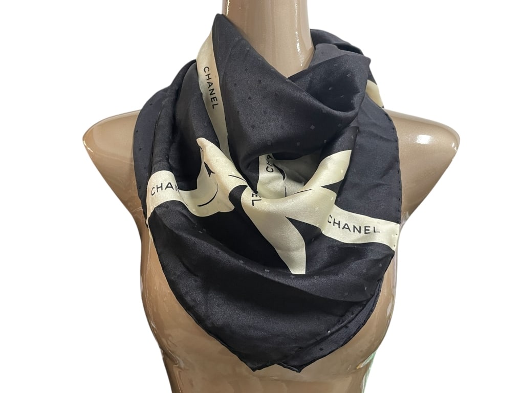 CHANEL BLACK AND CREAM GIFT RIBBON SILK SCARF 33": CHANEL BLACK AND CREAM GIFT RIBBON SILK SCARF 33" -Very good pre owned condition -Approx 33" -Sophisticated Chanel silk scarf in classic black, featuring a cream ribbon motif printed with the iconic C