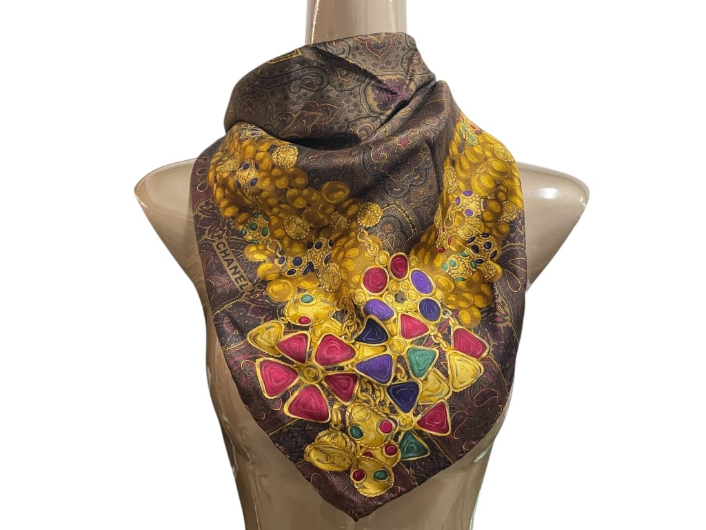 CHANEL JEWEL ENCRUSTED GOLD MOTIF SILK SCARF 34": CHANEL JEWEL ENCRUSTED GOLD MOTIF SILK SCARF 34" -Very good pre owned condition -Approx 34" -Magnificent Chanel silk scarf featuring a richly detailed jewel-encrusted gold design on a deep paisley-pat
