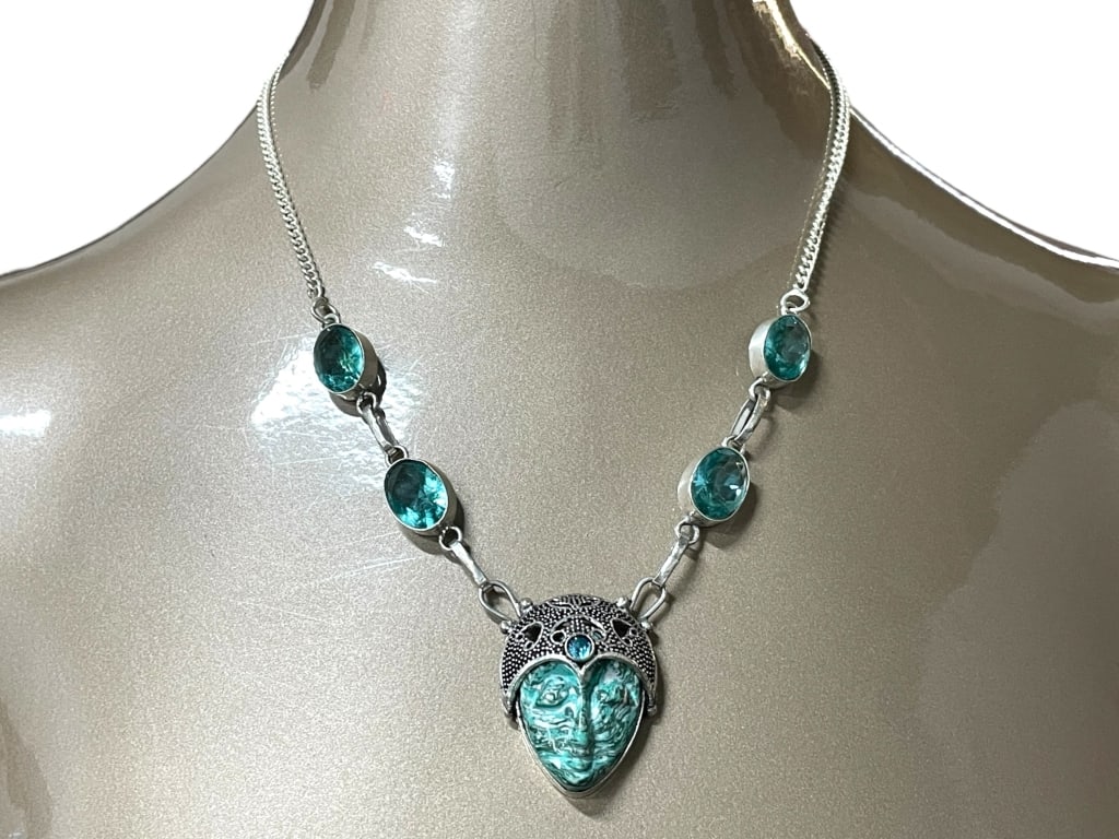 STERLING SILVER NECKLACE W TURQUOISE & TOPAZ 17G: STERLING SILVER NECKLACE W TURQUOISE & TOPAZ 17G -Very good pre owned condition -Approx 9.5"l -17G total weight -Elegant sterling silver necklace featuring four bezel-set oval blue gemstones leading t