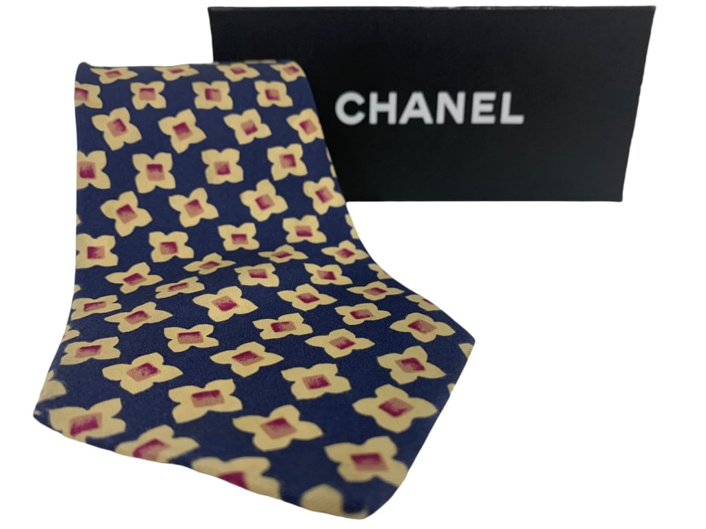 CHANEL PARIS FLORAL SILK NECKTIE – NAVY, YELLOW: "CHANEL PARIS FLORAL SILK NECKTIE – NAVY, YELLOW & MAGENTA FLORALElegant vintage Chanel Paris men’s necktie featuring a bold navy blue ground adorned with a repeating yellow and magenta geometric 