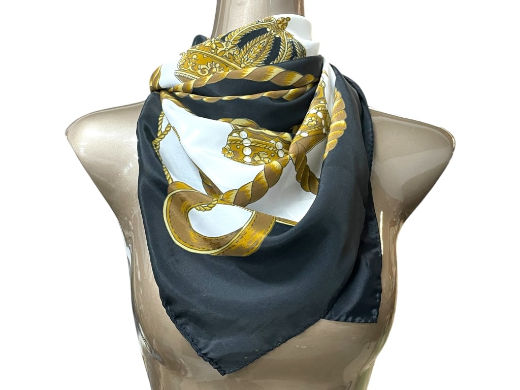 SILK STYLE SCARF W CROWN & ROPE MOTIF 34": SILK STYLE SCARF W CROWN & ROPE MOTIF 34" -Very good pre owned condition -Approx 34" -Scarf featuring a regal gold crown and rope motif on a classic black and white background -JA 110325 #PalmBeachSty