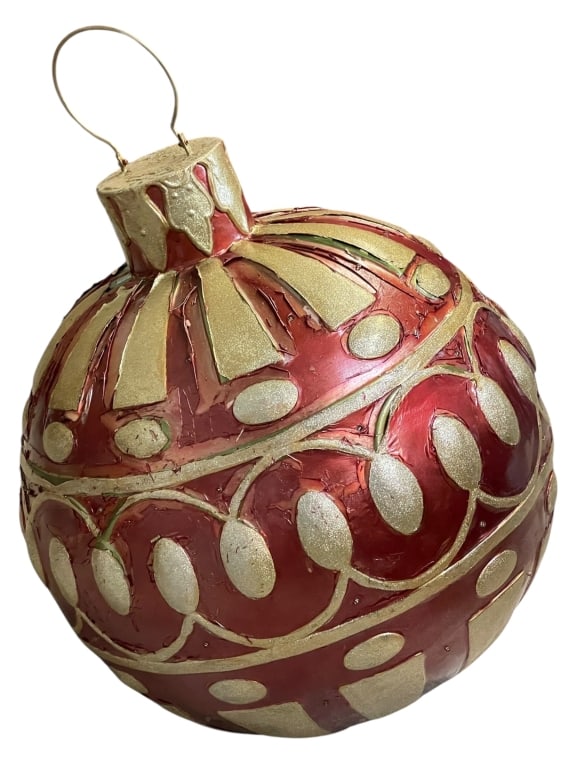 HUGE ILLUMINATED CHRISTMAS ORNAMENT FOR YARD: A MASSIVE ILLUMINATED CHRISTMAS ORNAMENT IS PRESENTED, SUITABLE FOR OUTDOOR DISPLAY. THE ORNAMENT IS A DEEP RED COLOR WITH SWIRLING, GOLD-COLORED ACCENTS AND A GOLD-PAINTED TOP. IT IS DECORATED WITH N