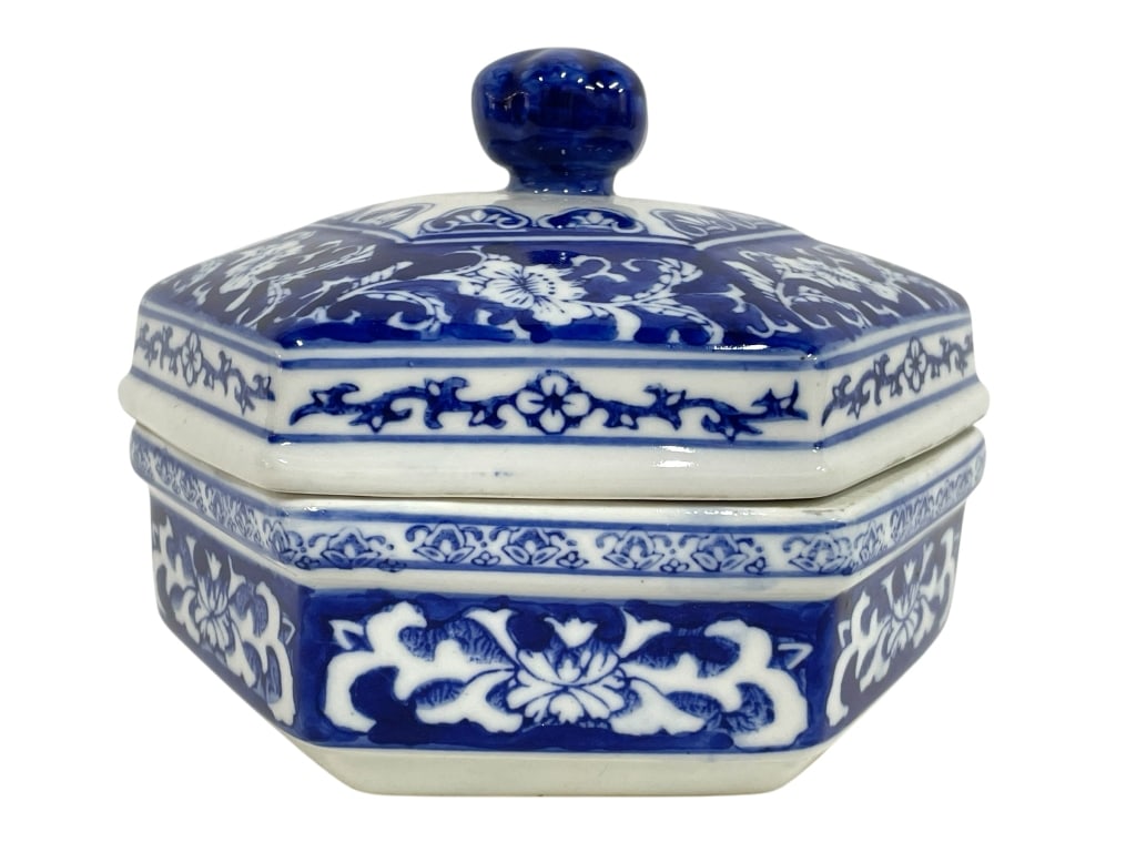 BLUE AND WHITE HEXAGONAL COVERED BOX 7": BLUE AND WHITE HEXAGONAL COVERED BOX 7" -Very good pre owned condition -Approx 5"h x 7"w -Elegant blue and white hexagonal covered porcelain box, beautifully hand-painted with intricate floral and vin