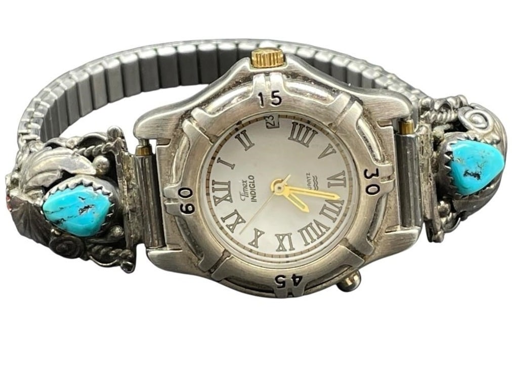 NAVAJO STERLING TURQUOISE FEATHER TRIM TIMEX WATCH: NAVAJO STERLING TURQUOISE FEATHER TRIM TIMEX WATCH - NAVAJO ARTISAN MADE SIGNED ON BACK BY ARTIST - STERLING SILVER TRIM WORK WITH FEATHERS AND TURQUOISE - STRETCH BRACELET ON THE BACK - TIMEX INTAGLI