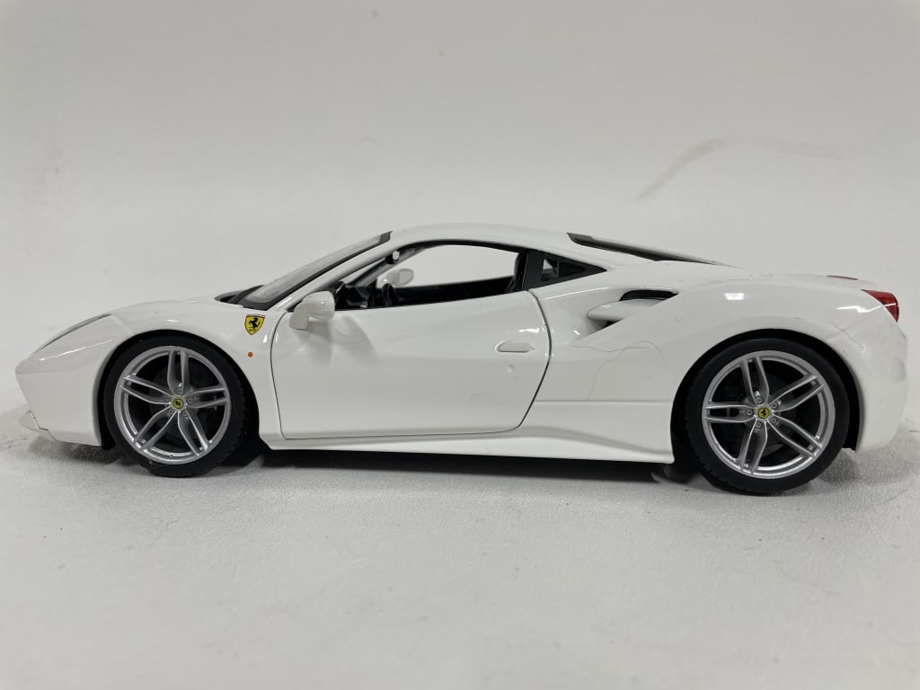 FERRARI 488 GTB DIECAST MODEL – WHITE FINISH 10": FERRARI 488 GTB DIECAST MODEL – WHITE FINISH 10" -Good pre owned condition -Approx 10"l -Elegant Ferrari 488 GTB diecast model car in sleek white with authentic detailing and precision craftsmanship