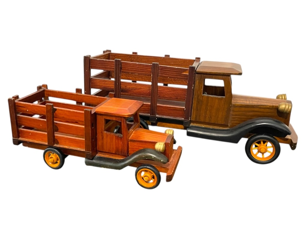 PAIR OF WOODEN VINTAGE STYLE TRUCKS 14": PAIR OF WOODEN VINTAGE STYLE TRUCKS 14" -Very good pre owned condition -Approx 7"h x 14"l (larger truck), 4"h x 10"l (small truck) -Wooden vintage-style trucks featuring open slat beds, black fenders,