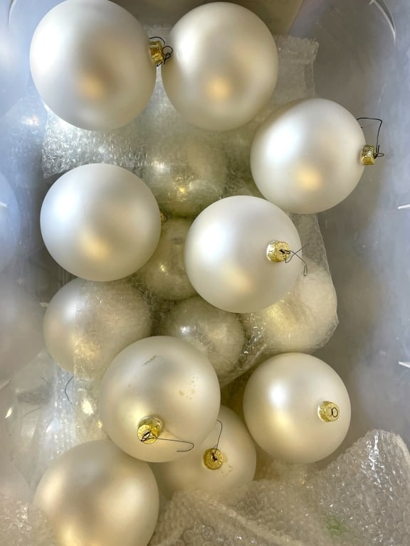 BIN OF WHITE SATIN FINISH ORNAMENTS: BIN OF WHITE SATIN FINISH ORNAMENTS -VARYING CONDITIONS, SEE PHOTOS -BIN OF WHITE SATIN FINISH ORNAMENTS PERFECT FOR HOLIDAY DECORATING OR CRAFTING. -JA 081925 By bidding on this item, you have read, 