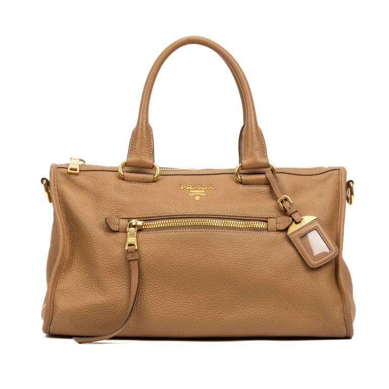 PRADA TWO WAY TOTE VITELLO PHOENIX SHOULDER BAG: The Prada Two Way Tote is a versatile design crafted in beige Vitello Phoenix calfskin leather. Featuring a detachable strap and luggage tag, this tote can be carried by hand or worn as a shoulder bag