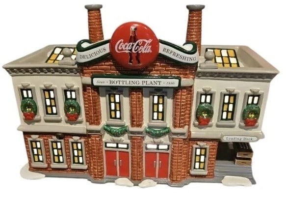 DEPARTMENT 56 COCA COLA BOTTLING PLANT W BOX: DEPARTMENT 56 COCA-COLA BOTTLING PLANT WITH BOXThis festive Department 56 Coca-Cola Bottling Plant features classic holiday charm with wreath-adorned windows, brick detailing, dual smokestacks, bright