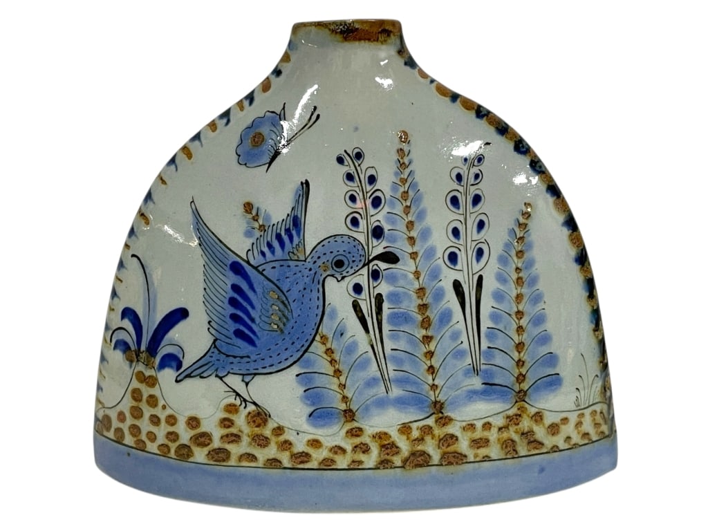 HAND-PAINTED FOLK ART CERAMIC VASE 8": HAND-PAINTED FOLK ART CERAMIC VASE 8" -Very good pre owned condition -Approx 7"h x 8"w x 3"d -This charming folk art ceramic vase features a whimsical hand-painted design of a blue bird surrounded by