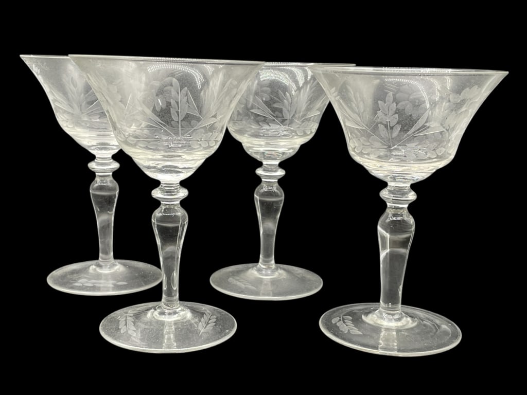4 ETCHED GLASS COCKTAIL / CHAMPAGNE STEMS 5": 4 ETCHED GLASS COCKTAIL / CHAMPAGNE STEMS WITH FLORAL & LEAF MOTIF -Very good pre owned condition -Set of 4 glasses -Approx 5"h x 3"w -This refined set of four vintage etched glass stems features a gr