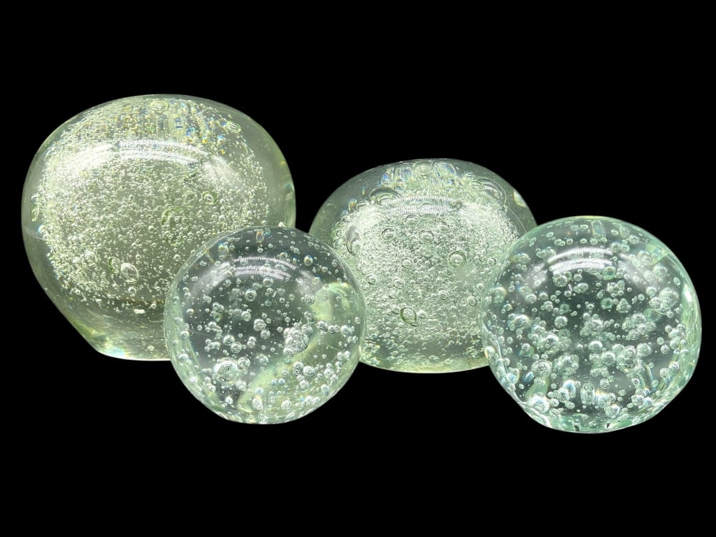 SET OF 4 ART GLASS PAPERWEIGHT SCULPTURES 4.5": SET OF 4 ART GLASS BULLICANTE CONTROLLED BUBBLE PAPERWEIGHTS — Elegant group of four heavy art glass spheres, each filled with controlled air bubbles creating a sparkling underwater effect. Clear gl