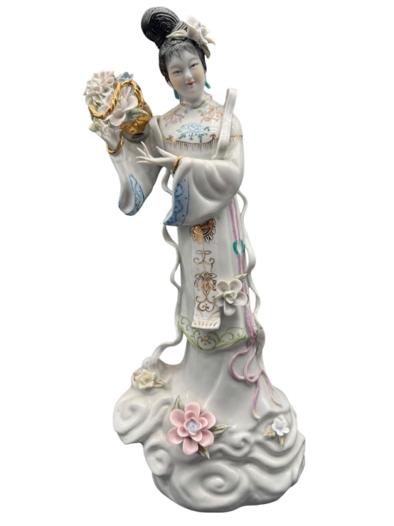 PORCELAIN FIGURINE OF ASIAN LADY WITH FLORAL 16": PORCELAIN FIGURINE OF ASIAN LADY WITH FLORAL BOUQUET -This elegant hand-painted porcelain figurine depicts an Asian lady gracefully posed with a detailed floral bouquet, showcasing finely modeled appl