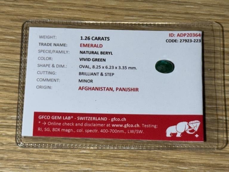 CERTIFIED 1.26 CARAT NATURAL EMERALD: This certified natural emerald weighs 1.26 carats and is authenticated by GFCO Gem Lab, Switzerland. The gemstone displays a desirable vivid green coloration and is cut in a classic oval brilliant/ste