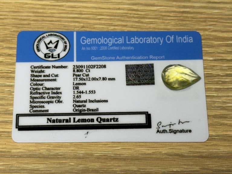 CERTIFIED 17.52 CARAT NATURAL LEMON QUARTZ: This vibrant natural lemon quartz weighs an impressive 17.52 carats and is certified by the Gemological Laboratory of India (GLI). Cut in a striking pear-shaped faceted design, this gemstone measures