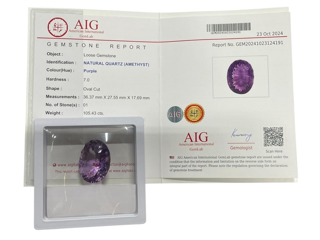 AIG CERTIFIED 105.43 CARAT NATURAL AMETHYST: AIG CERTIFIED 105.43 CARAT NATURAL AMETHYST – EXTRA LARGE OVAL CUT -This extraordinary certified natural amethyst weighs an impressive 105.43 carats, making it a striking centerpiece for collectors 