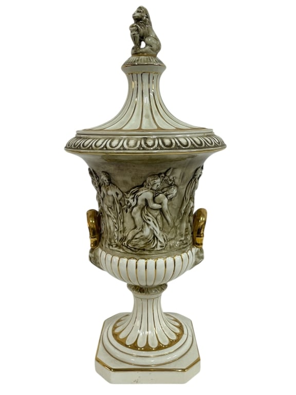 CAPODIMONTE COVERED URN WITH FIGURAL RELIEF 21": CAPODIMONTE COVERED URN WITH FIGURAL RELIEF AND GOLD ACCENTS -Very good pre owned condition -Approx 21"h x 9"w -Featuring finely sculpted high-relief figures of maidens in flowing robes, surrounded by